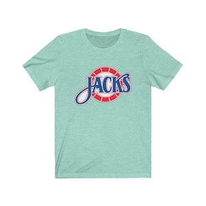May include: A teal blue t-shirt with a red and blue logo that says "Jacks" in a white circle with red and white stripes.
