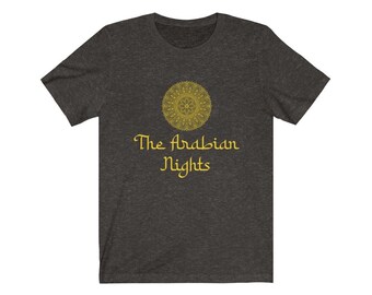 May include: A dark heather grey t-shirt with a gold mandala design and the text "The Arabian Nights" in gold.