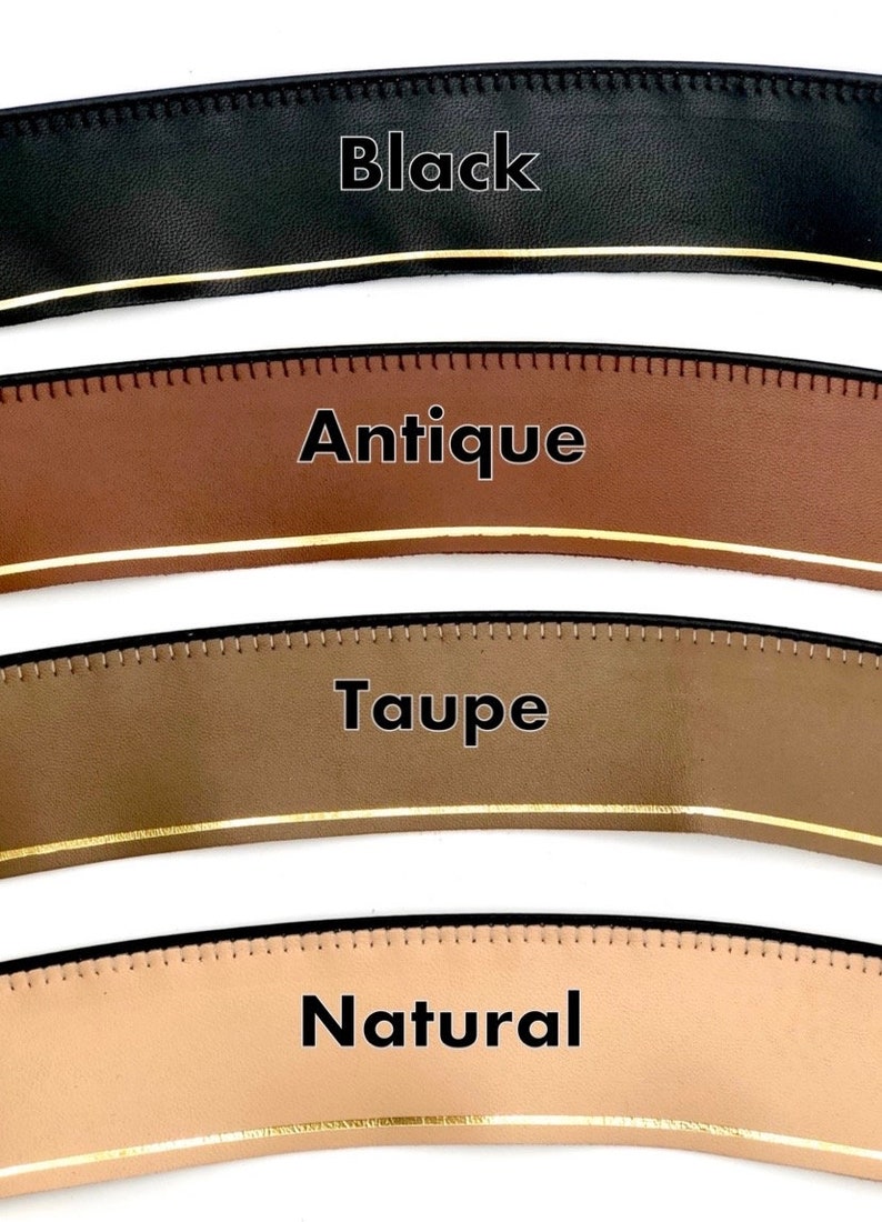 May include: Four leather straps in different colours: black, antique brown, taupe, and natural. Each strap has a gold line running along the edge.