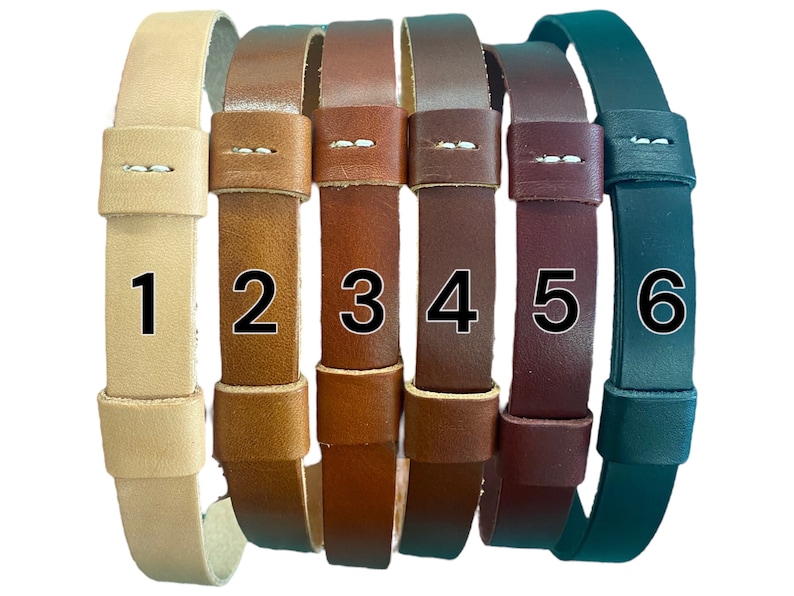 May include: Six leather straps in different colors, numbered 1 through 6. The straps are all the same width and have a simple design.