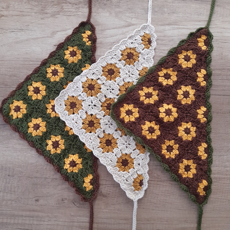 May include: Three crocheted triangle shawls in green, white, and brown with a sunflower pattern.