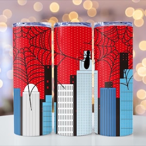 Puede incluir: Tres vasos de acero inoxidable con fondo rojo punteado. Cada vaso presenta un dise&ntilde;o de telara&ntilde;a negra y una silueta de paisaje urbano. Uno presenta una ara&ntilde;a negra. Dise&ntilde;ados para bebidas fr&iacute;as.