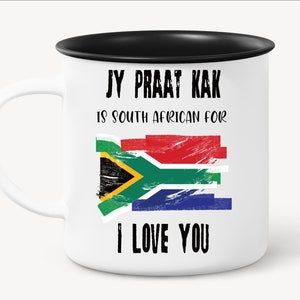 May include: White ceramic mug with a black rim. The mug has a South African flag and the text "Jy Praat Kak is South African for I Love You".