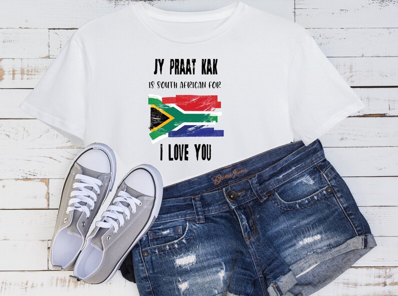 May include: White t-shirt with a distressed South African flag and the text "Jy Praat Kak is South African for I Love You."