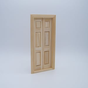 May include: A wooden double door with six raised panels, a simple design for a dollhouse or miniature project.
