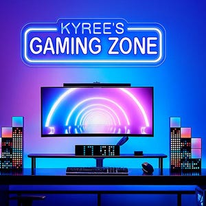 Peut inclure: Une configuration de jeu avec une enseigne au néon indiquant "KYREE'S GAMING ZONE". Le bureau comprend un écran affichant un design de tunnel coloré, un clavier et une souris. La pièce est éclairée par un éclairage bleu et violet, et une chaise de jeu est visible.
