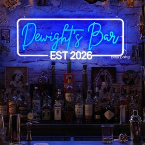 May include: A blue neon sign reading "Dwight's Bar" with "EST 2026" underneath, mounted on a brick wall. The bar is stocked with bottles and glasses, creating a classic bar atmosphere.