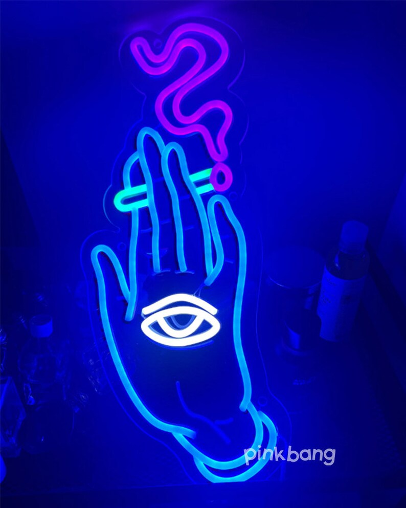 May include: A blue neon sign depicting a hand holding a cigarette with smoke rising above it. The hand has an eye in the palm. The sign has the text "pinkbang" at the bottom.