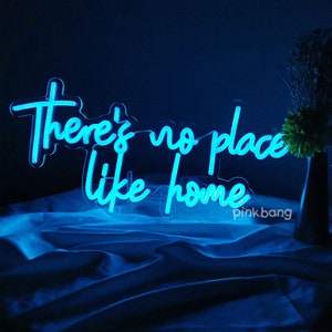 May include: Blue neon sign with the text "There's no place like home".