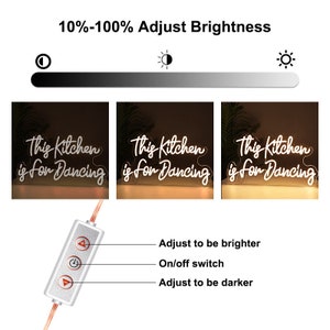 May include: White neon sign with the text "This Kitchen is for Dancing" on a clear acrylic base. The sign is illuminated and has a dimmer switch to adjust the brightness.