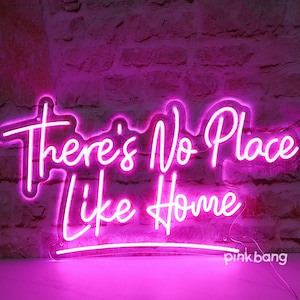 May include: Pink neon sign with the text "There's No Place Like Home".