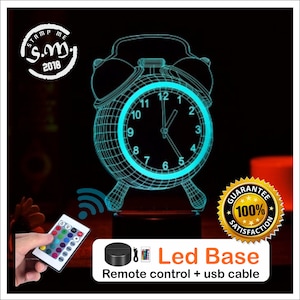 May include: A 3D printed alarm clock night light with a blue glow. The clock is on a black base with a remote control and USB cable. The remote control has 16 color options.
