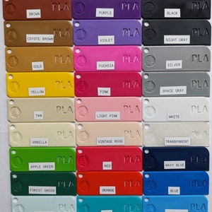 May include: A color chart of 18 different PLA filament colors for 3D printing. The colors include brown, purple, black, coyote brown, violet, night gray, gold, fuchsia, silver, yellow, pink, space gray, tan, light pink, white, vanilla, vintage rose, transparent, apple green, red, navy blue, forest green, orange, blue, baby blue, teal, and light blue.