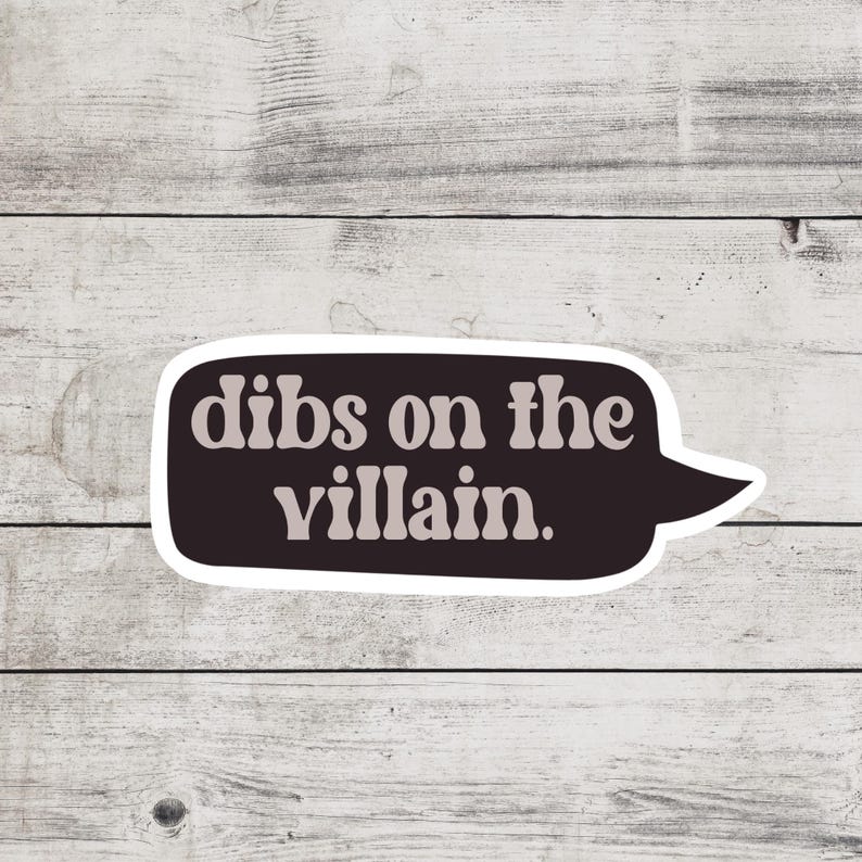 May include: A black and white speech bubble sticker with the text "Dibs on the villain." in a retro font.