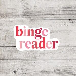 May include: A white sticker with the text "binge reader" in pink and red gradient lettering.