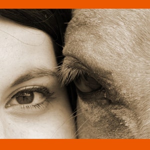 May include: A close-up of a woman's eye and a horse's eye, both looking in the same direction. The woman's eye is closed, while the horse's eye is open. The image is in sepia tone.