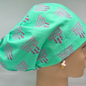 May include: A turquoise blue scrub hat with a pink repeating pattern that says "ever wonder what a cool scrub tech looks like?"