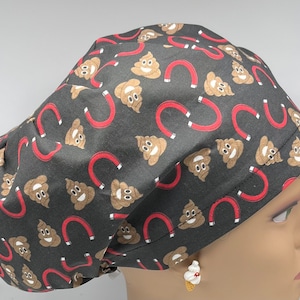 May include: A black scrub hat with a repeating pattern of brown poop emojis and red horseshoe magnets.