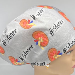 May include: Gray surgical scrub hat with a repeating pattern of red and orange kidneys and the text "#stoner" in black.