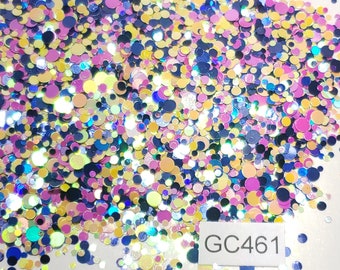 May include: A close-up shot of a pile of colorful, round glitter pieces. The glitter is a mix of blue, pink, yellow, and iridescent colors. The text "GC461" is visible in the bottom right corner. The glitter is scattered across a white surface.