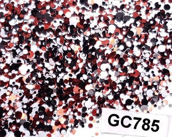 May include: A pile of red, black, silver, and white glitter in various sizes. The glitter is on a white background with a white label that says "GC785".