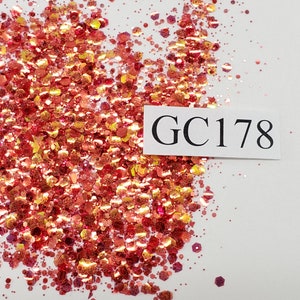 May include: A close-up of a pile of red, orange, and gold glitter with a white label that says "GC178".