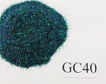 May include: A pile of dark green glitter with a iridescent sheen. The glitter is labeled GC40.
