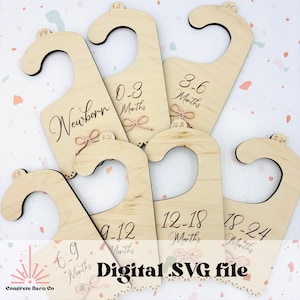 May include: Set of six wooden hangers with a hook at the top and a cut-out heart shape at the bottom. Each hanger is labeled with a different age range in months: Newborn, 0-3 Months, 3-6 Months, 6-9 Months, 9-12 Months, 12-18 Months, 18-24 Months. The hangers are a light wood color and have a distressed finish. The text on the hangers is in a black font. The text "Digital .SVG file" is at the bottom of the image.