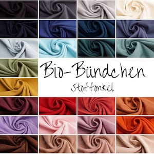 Könnte beinhalten: Eine Stoffmuster-Anzeige mit einer Vielzahl von Farben, darunter Blau-, Grün-, Gelb-, Rot- und Brauntöne. Das Bild enthält den Text "Bio-Bündchen Stoffonkel" in schwarzer Schrift und zeigt eine Auswahl an Textiloptionen.