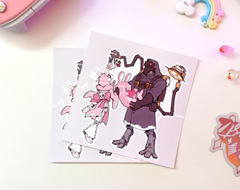 Può includere: Due adesivi con un'illustrazione di cartone animato di un coniglio rosa che tiene un cuore rosa e un personaggio nero con una maschera antigas e una chiave inglese. Gli adesivi sono su uno sfondo bianco.