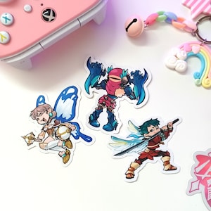 May include: Three colorful cartoon character stickers featuring a blue and white fairy, a red and blue creature with wings, and a green-haired character with wings and a sword.