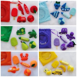 May include: A set of felt color matching bags with various felt objects, including a red fire truck, a green frog, a purple octopus, and a yellow school bus. Each bag has a color name on it, such as "Red", "Green", "Purple", and "Yellow".