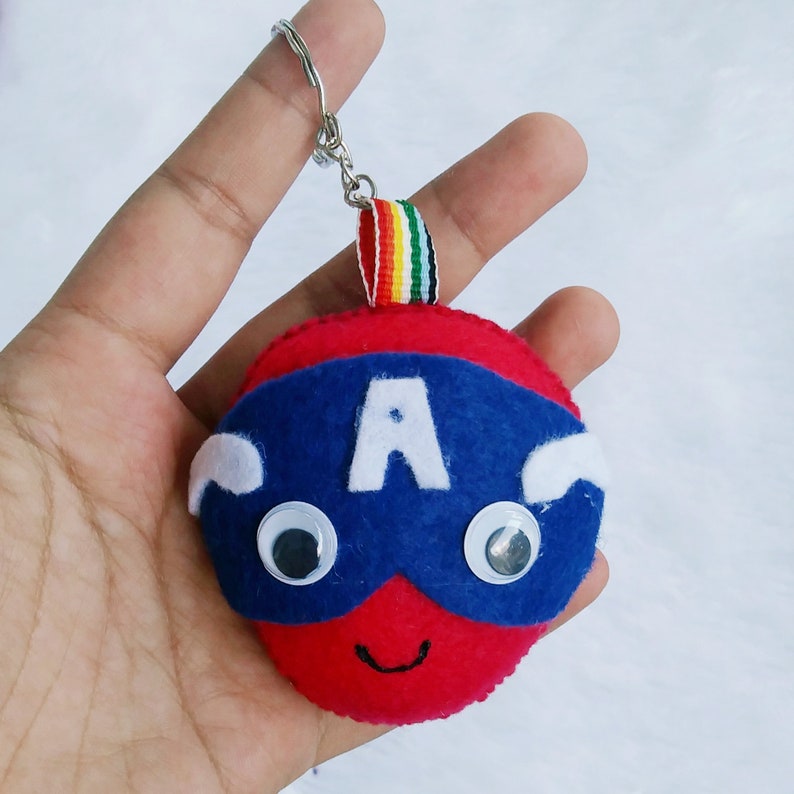 May include: Red and blue felt keychain with a superhero mask, white letter A, and googly eyes.