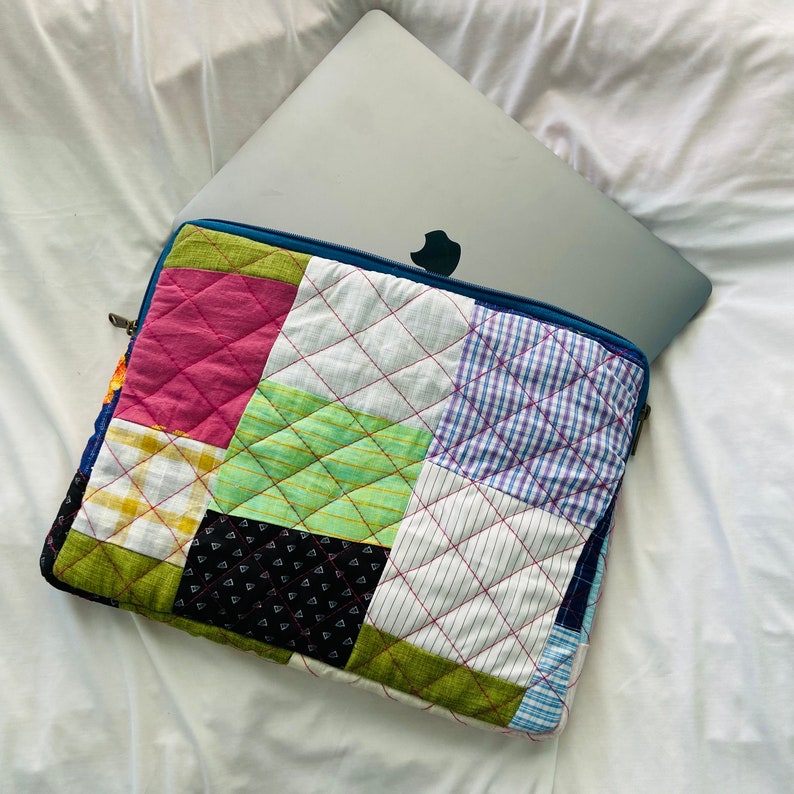 laptop cover, case cover for macbook air, cover for hp laptop, laptop sleeves all sizes, cute laptop sleeves, quilted laptop cover, puffy laptop sleeve, laptop sleeve 13 inch macbook air, laptop sleeve, laptop sleeve custom size, laptop cover 15 inch, An eco-friendly laptop sleeve showcasing a mix of vibrant, multicolor solid patchwork fabric pieces, creating a bold and eye-catching design. The quilted, puffy construction ensures your laptop is well-protected.