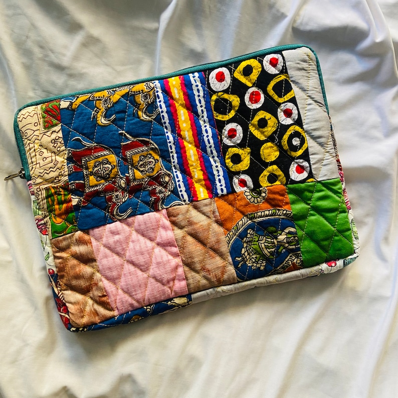 laptop cover, case cover for macbook air, cover for hp laptop, laptop sleeves all sizes, cute laptop sleeves, quilted laptop cover, puffy laptop sleeve, laptop sleeve 13 inch macbook air, laptop sleeve, laptop sleeve custom size, laptop cover 15 inch, An eco-friendly laptop sleeve showcasing a mix of vibrant, multicolor solid patchwork fabric pieces, creating a bold and eye-catching design. The quilted, puffy construction ensures your laptop is well-protected