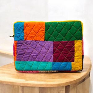 laptop cover, case cover for macbook air, cover for hp laptop, laptop sleeves all sizes, cute laptop sleeves, quilted laptop cover, puffy laptop sleeve, laptop sleeve 13 inch macbook air, laptop sleeve, laptop sleeve custom size, laptop cover 15 inch, An eco-friendly laptop sleeve showcasing a mix of vibrant, multicolor solid patchwork fabric pieces, creating a bold and eye-catching design. The quilted, puffy construction ensures your laptop is well-protected.