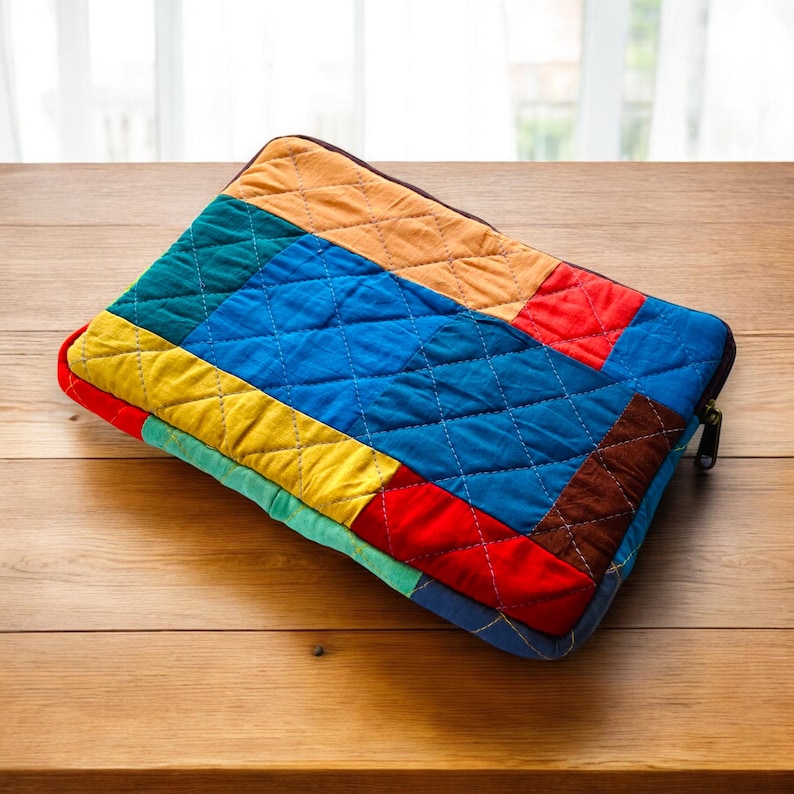 laptop cover, case cover for macbook air, cover for hp laptop, laptop sleeves all sizes, cute laptop sleeves, quilted laptop cover, puffy laptop sleeve, laptop sleeve 13 inch macbook air, laptop sleeve, laptop sleeve custom size, laptop cover 15 inch, An eco-friendly laptop sleeve showcasing a mix of vibrant, multicolor solid patchwork fabric pieces, creating a bold and eye-catching design. The quilted, puffy construction ensures your laptop is well-protected.