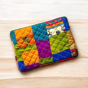 laptop cover, case cover for macbook air, cover for hp laptop, laptop sleeves all sizes, cute laptop sleeves, quilted laptop cover, puffy laptop sleeve, laptop sleeve 13 inch macbook air, laptop sleeve, laptop sleeve custom size, laptop cover 15 inch, An eco-friendly laptop sleeve showcasing a mix of vibrant, multicolor solid patchwork fabric pieces, creating a bold and eye-catching design. The quilted, puffy construction ensures your laptop is well-protected.