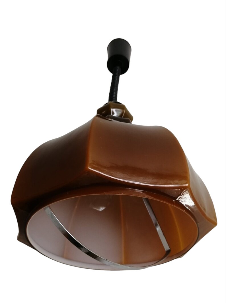 May include: A brown ceramic pendant light fixture with a white inner shade and a black cord.