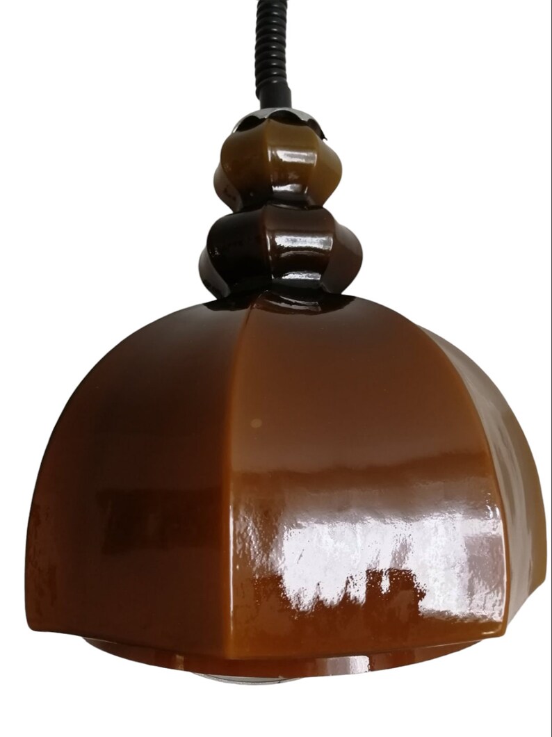 May include: A brown ceramic pendant light with a dome-shaped shade and a three-tiered, bulbous top.