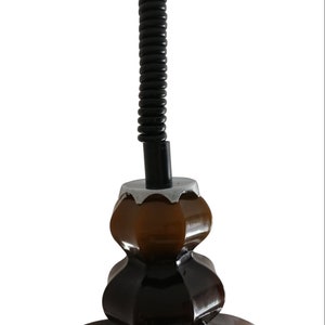 May include: A brown ceramic pendant light fixture with a black coiled cord.