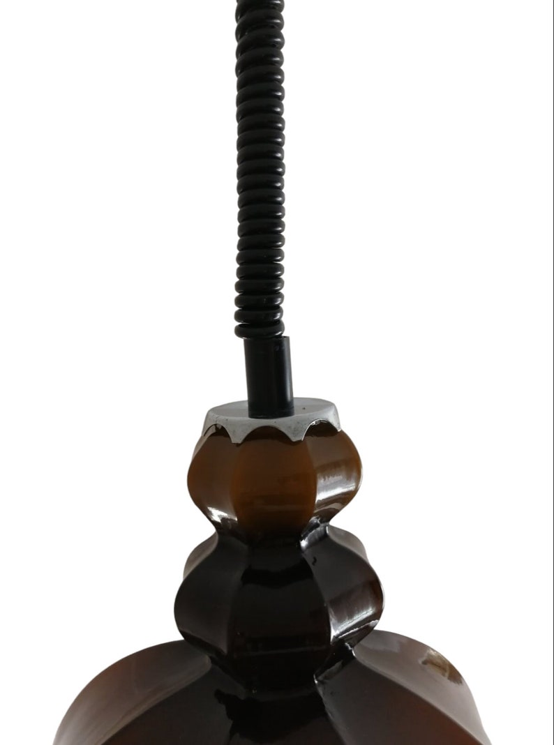 May include: A brown ceramic pendant light fixture with a black coiled cord.