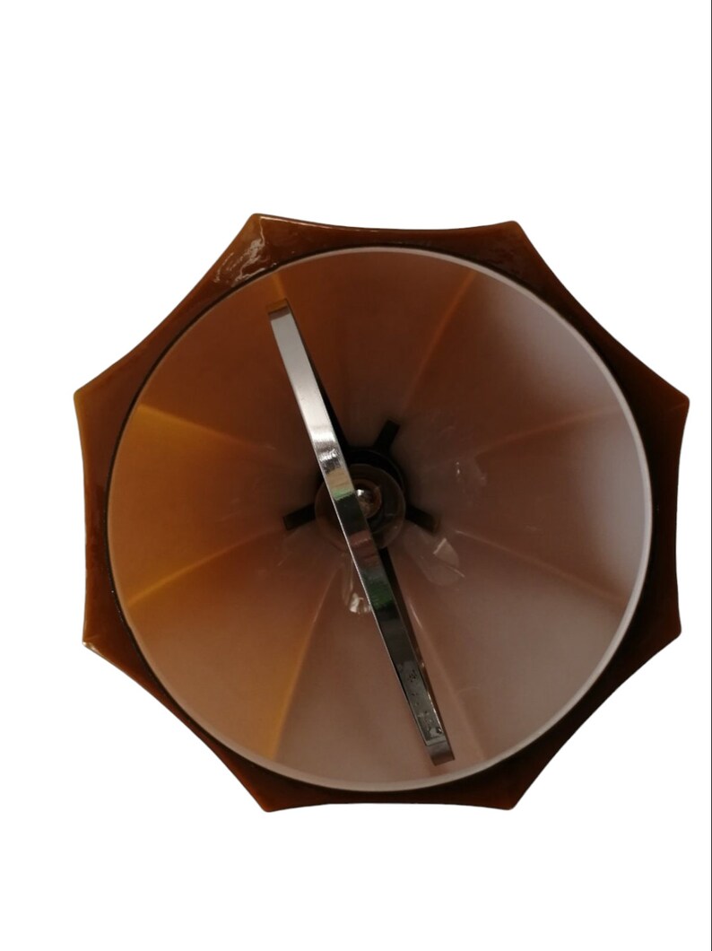 May include: A brown umbrella-shaped lampshade with a metal frame and a white interior. The lampshade is designed to be used with a standard light bulb.
