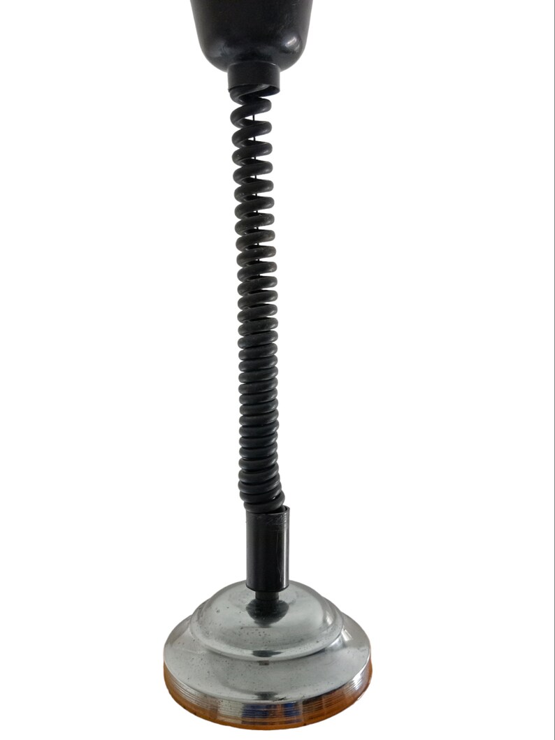 May include: A black and silver hanging lamp with a spring-coil cord.