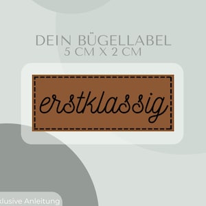 May include: Brown iron-on label with the text "erstklassig" in black cursive font. The label is 5 cm by 2 cm and includes instructions for ironing.