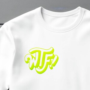 May include: White t-shirt with a neon green graphic that says "WTF!" in a stylized font.