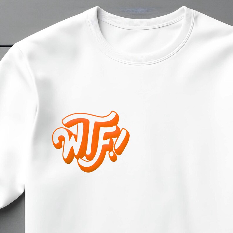 May include: White t-shirt with an orange graphic that says "WTF!" in a stylized font.