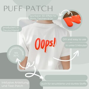 May include: A white t-shirt with a red 3D puffy patch that says "OOPS!" on the back. The patch is machine washable up to 30 degrees Celsius. The image also shows a close-up of a red puffy patch with the letter "N" on it. The text on the image says "Puff Patch", "Sp&uuml;rbarer 3D-Effekt f&uuml;r Shirts, Taschen & Co.", "produziert in Deutschland", "DIY and easy to use in unter 5 Minuten", "Inklusive Anleitung und Test-Patch", and "auch f&uuml;r struktierte und dunkle Stoffe".