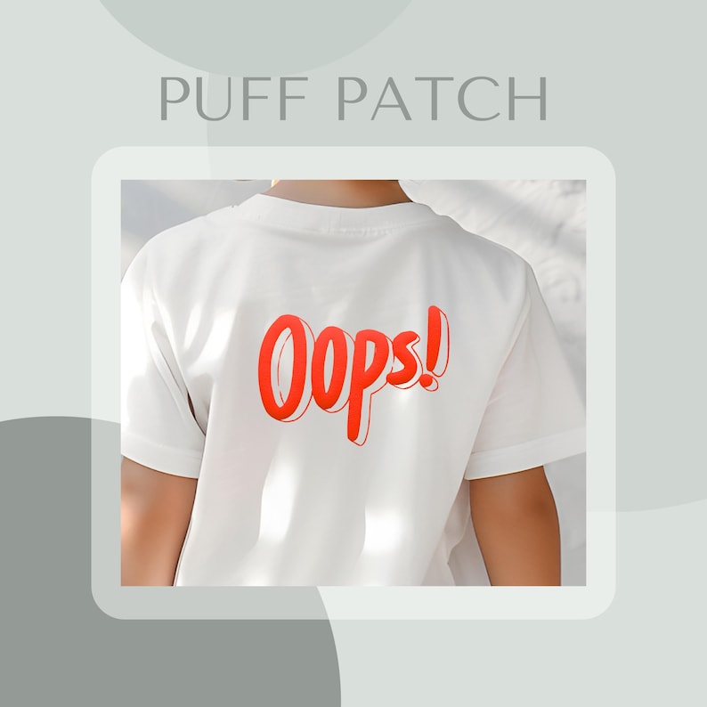 May include: White t-shirt with a red "Oops!" graphic on the back. The graphic is in a puffy, 3D style.