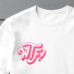 May include: White sweatshirt with a pink "WTF!" graphic printed on the front.